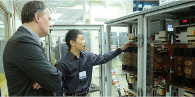 Two researchers examine equipment